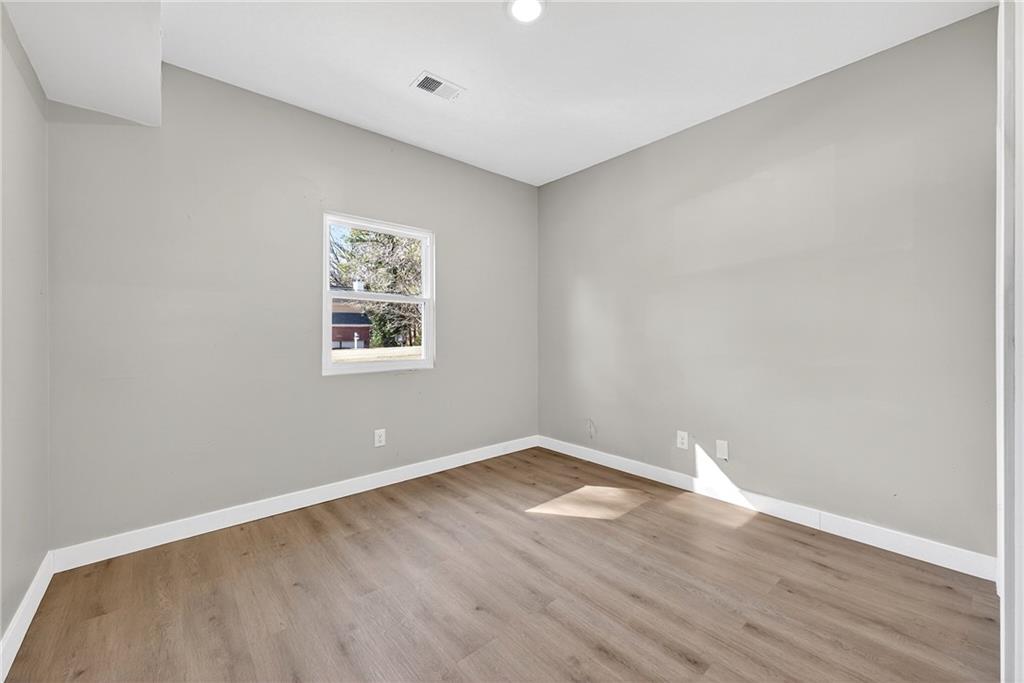 2874 Fairburn Road Southwest Atlanta, GA 30331 - Photo 22 of 34 a view of a big room with wooden floor and windows