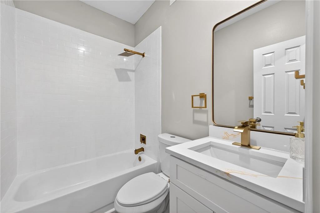 2874 Fairburn Road Southwest Atlanta, GA 30331 - Photo 23 of 34 a bathroom with a granite countertop sink toilet and shower