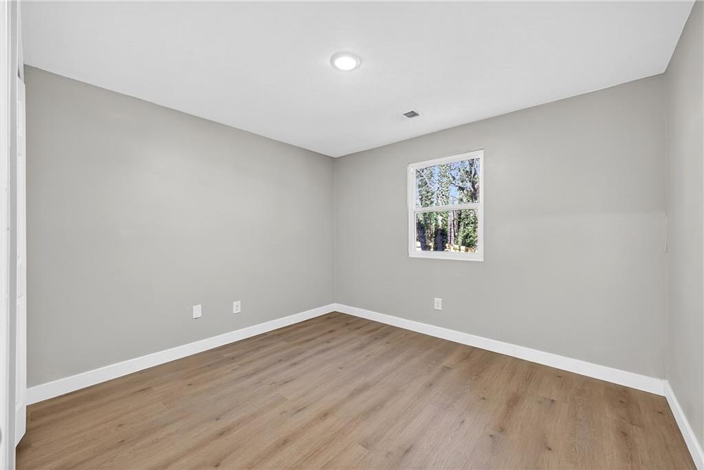 2874 Fairburn Road Southwest Atlanta, GA 30331 - Photo 24 of 34 wooden floor in an empty room with a window