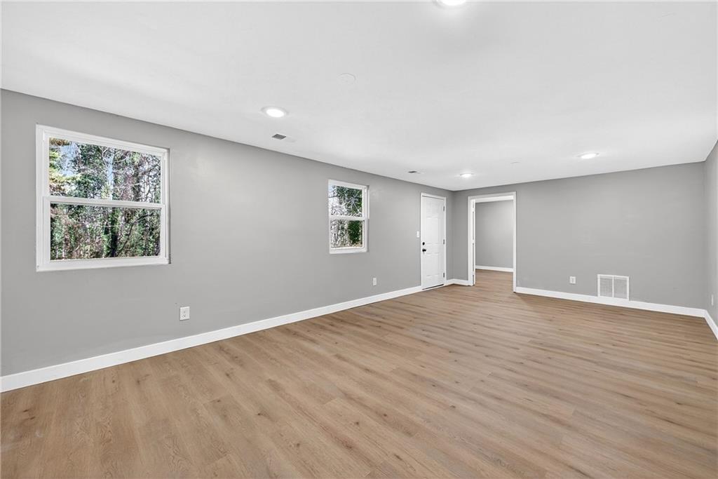 2874 Fairburn Road Southwest Atlanta, GA 30331 - Photo 25 of 34 a view of an empty room with wooden floor and a window