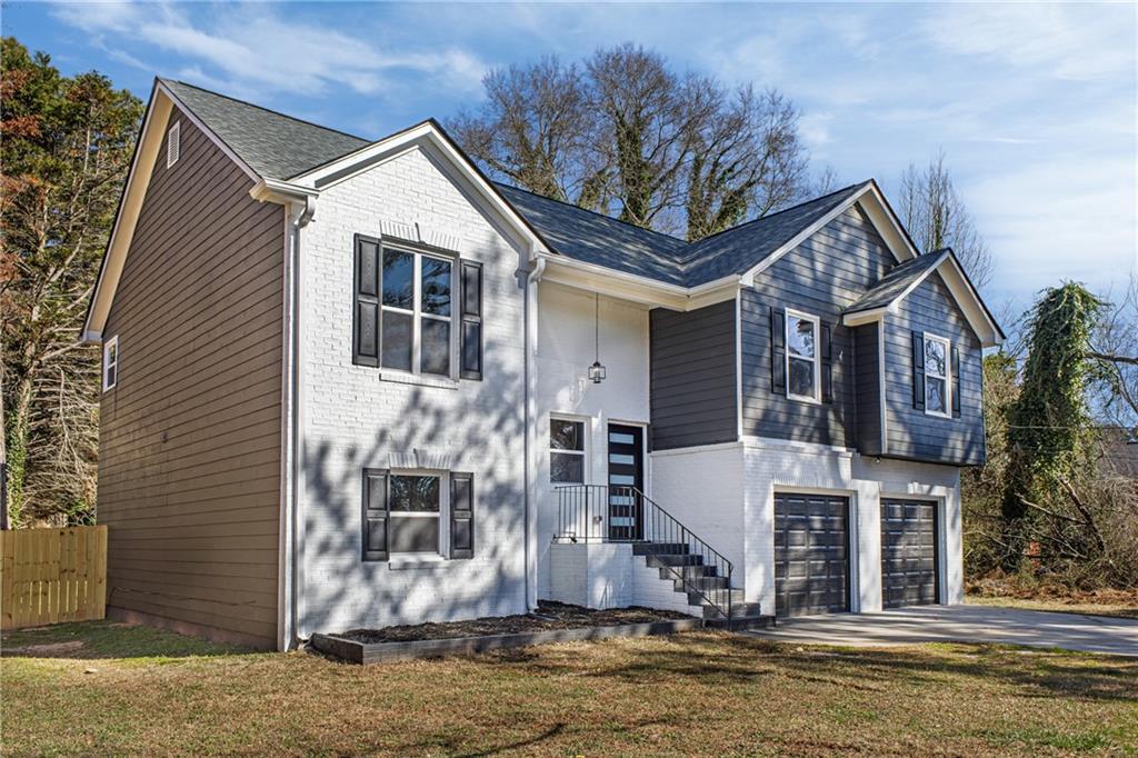 2874 Fairburn Road Southwest Atlanta, GA 30331 - Photo 3 of 34 a front view of a house with a yard
