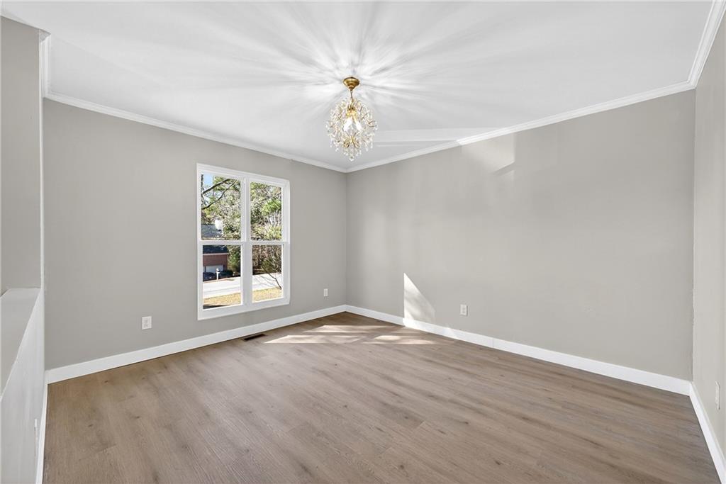 2874 Fairburn Road Southwest Atlanta, GA 30331 - Photo 6 of 34 wooden floor in an empty room with a window