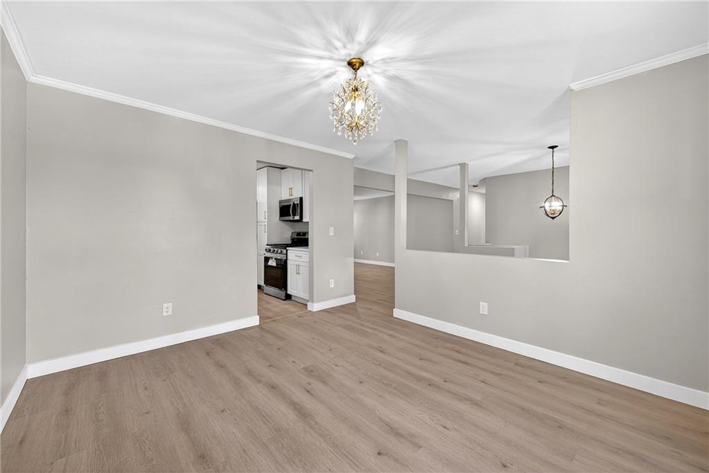 2874 Fairburn Road Southwest Atlanta, GA 30331 - Photo 7 of 34 wooden floor in an empty room with a window