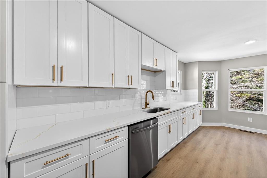 2874 Fairburn Road Southwest Atlanta, GA 30331 - Photo 8 of 34 a kitchen with granite countertop white cabinets and white appliances