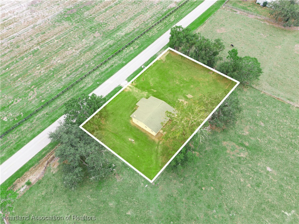 657 North Hollandtown Road Wauchula, FL 33873 - Photo 24 of 25 a green field with lots of trees in the background