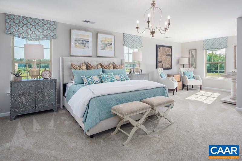 1617 Fowler Ridge Court Charlottesville, VA 22901 - Photo 11 of 23 a spacious bedroom with a bed and a chandelier
