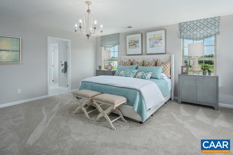 1617 Fowler Ridge Court Charlottesville, VA 22901 - Photo 12 of 23 a bedroom with a bed and a chandelier