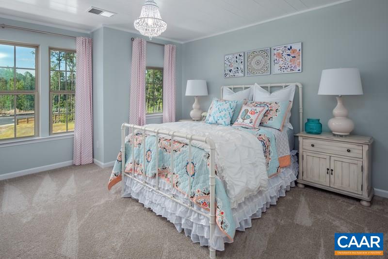 1617 Fowler Ridge Court Charlottesville, VA 22901 - Photo 16 of 23 a bedroom with a bed chandelier and a window