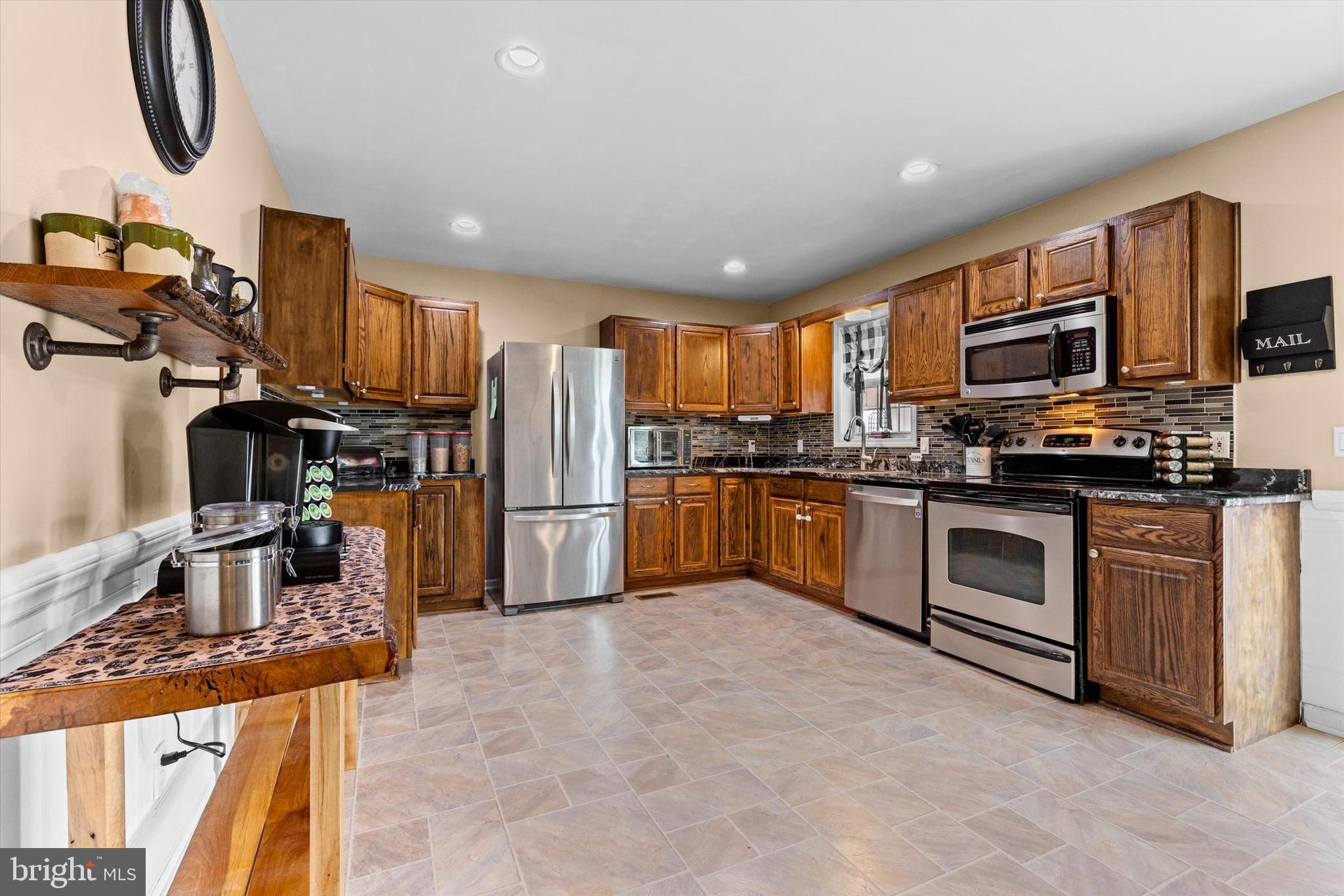 635 Newport Road Duncannon, PA 17020 - Photo 13 of 55 a kitchen with stainless steel appliances granite countertop a stove top oven a sink a refrigerator and white cabinets