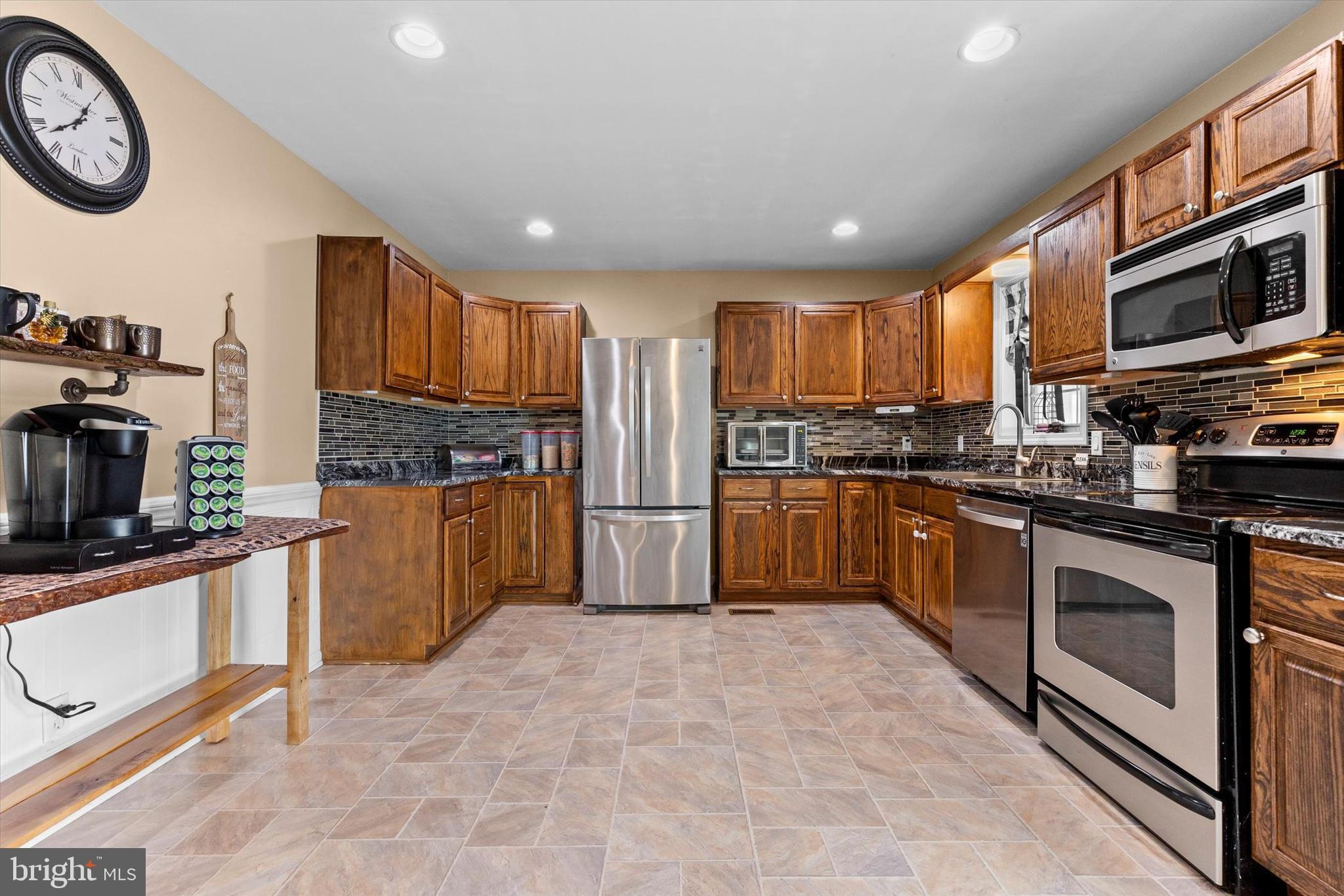 635 Newport Road Duncannon, PA 17020 - Photo 14 of 55 a kitchen with stainless steel appliances granite countertop a stove top oven a sink a stove and a refrigerator