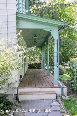 a view of backyard with outdoor seating and green space