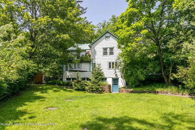 a front view of house with yard and green space
