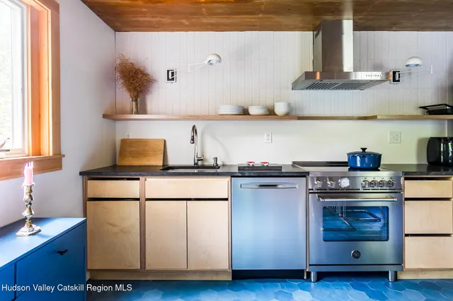 a kitchen with stainless steel appliances granite countertop a sink stove and cabinets