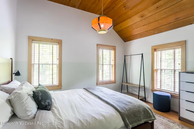 a bedroom with a large bed and a large window