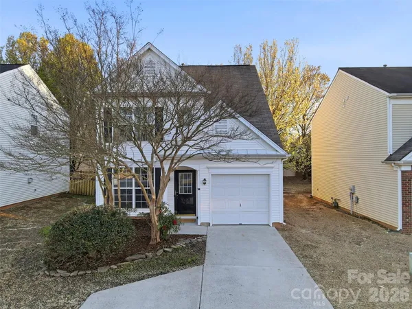 a view of a house with a yard and garage