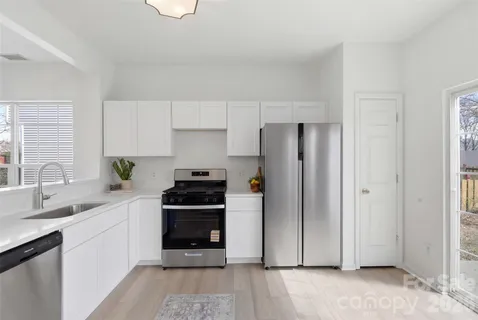 a kitchen with a stove a sink and a refrigerator