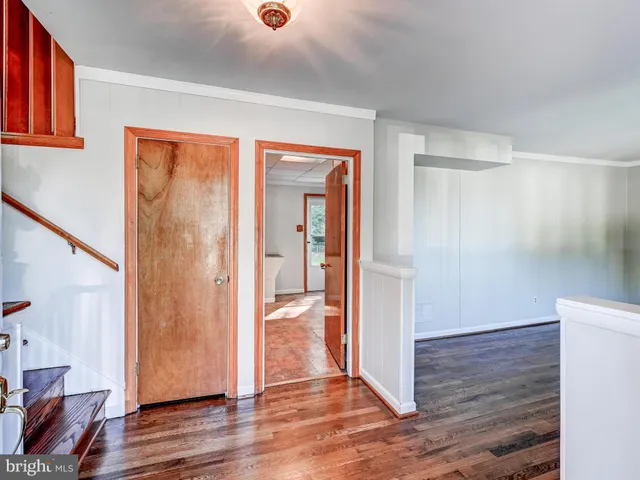 a view of empty room with wooden floor