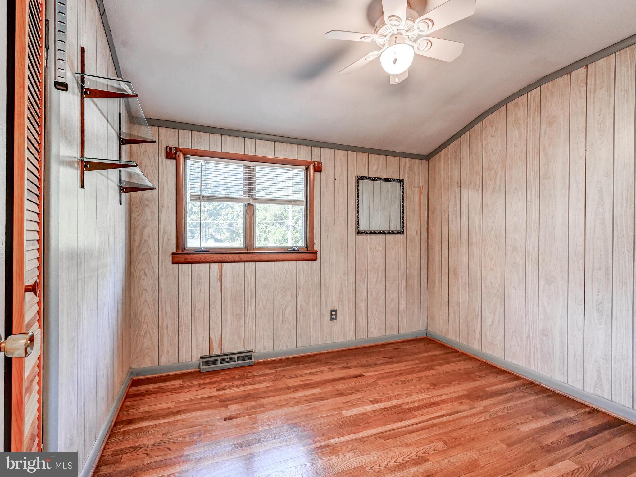 609 South Rogers Street Aberdeen, MD 21001 - Photo 13 of 45 an empty room with wooden floor fan and windows