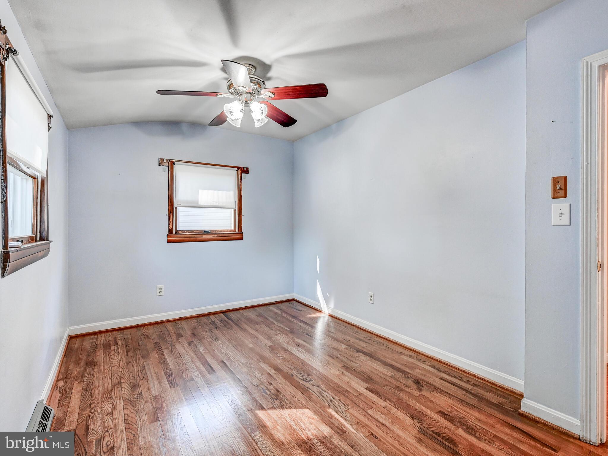 609 South Rogers Street Aberdeen, MD 21001 - Photo 15 of 45 a view of an empty room with wooden floor and a window