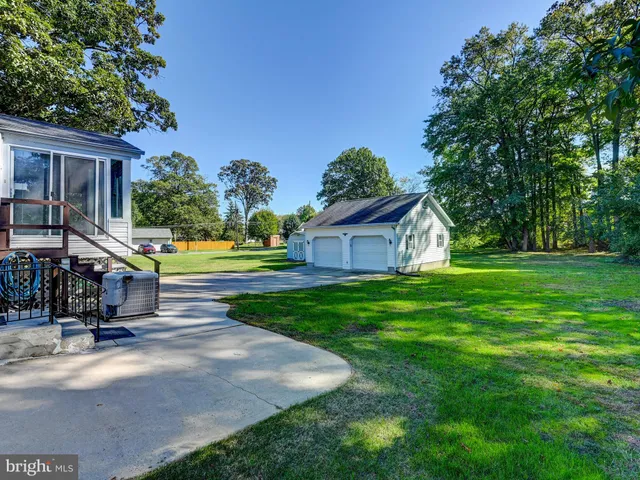 a view of house with backyard and tree