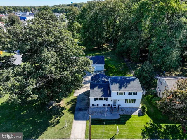 a view of a house with a yard and potted plants