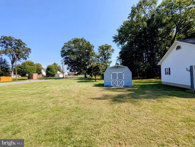 a front view of house with yard and trees