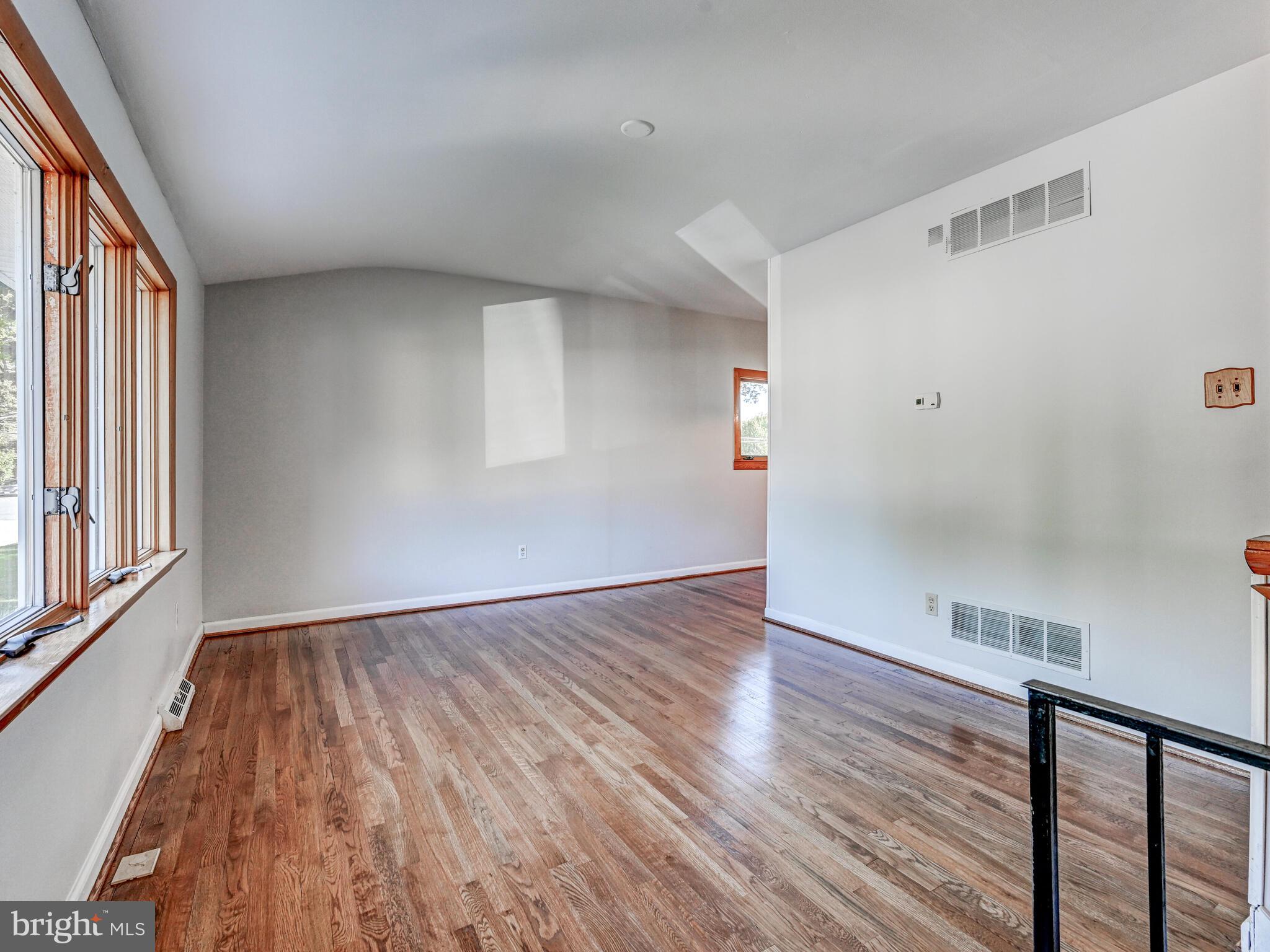 609 South Rogers Street Aberdeen, MD 21001 - Photo 6 of 45 a view of an empty room with wooden floor and a window