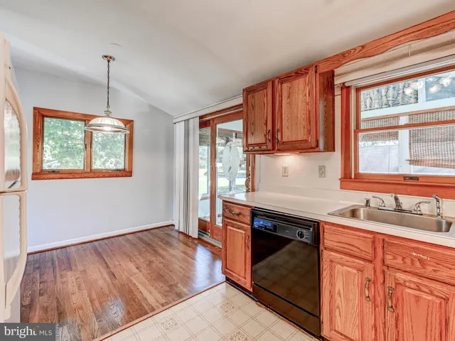 a kitchen that has a sink stove and cabinets