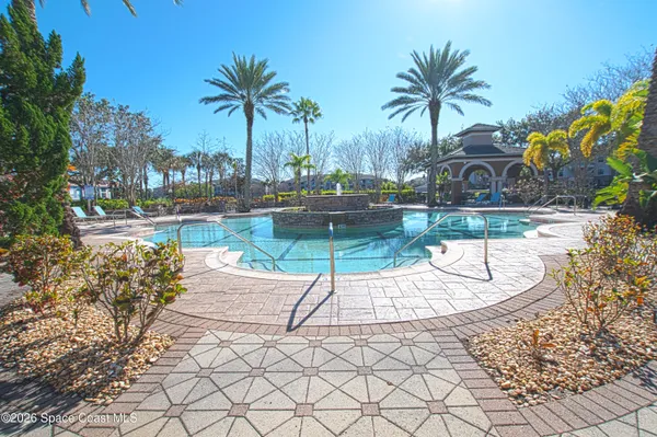 a view of a swimming pool with a patio and a garden
