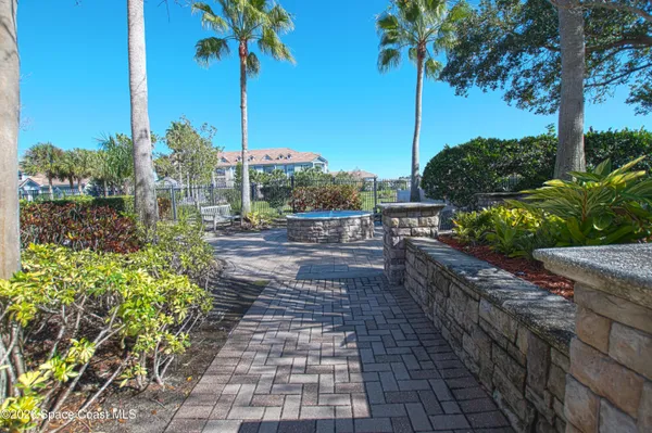 a view of a pathway statue with a garden