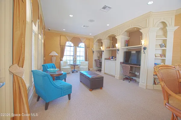 a living room with furniture and large windows