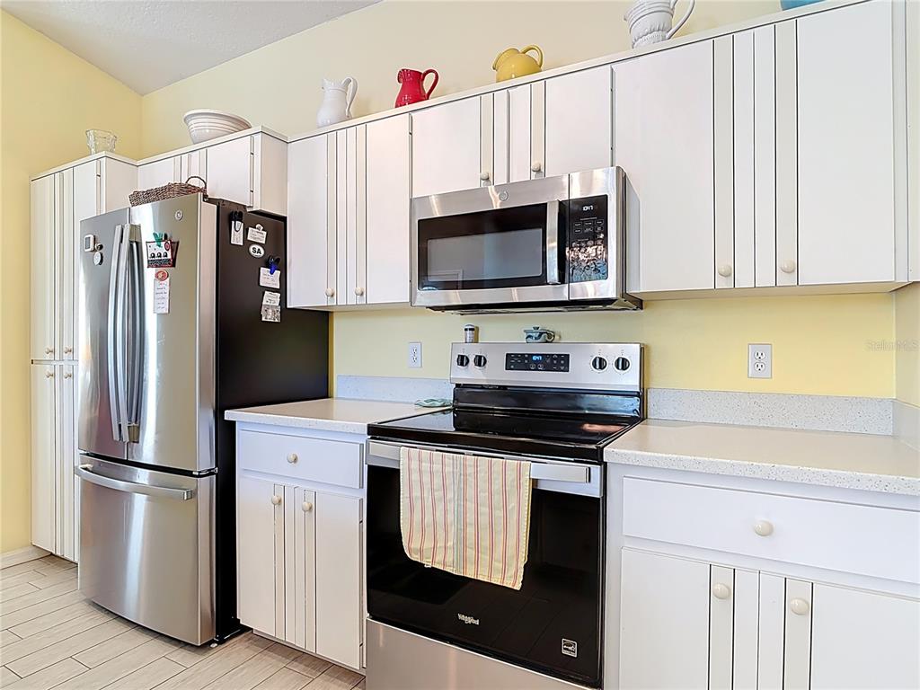 1408 3rd Street Edgewater, FL 32132 - Photo 11 of 43 a kitchen with stainless steel appliances granite countertop a stove a refrigerator and a microwave