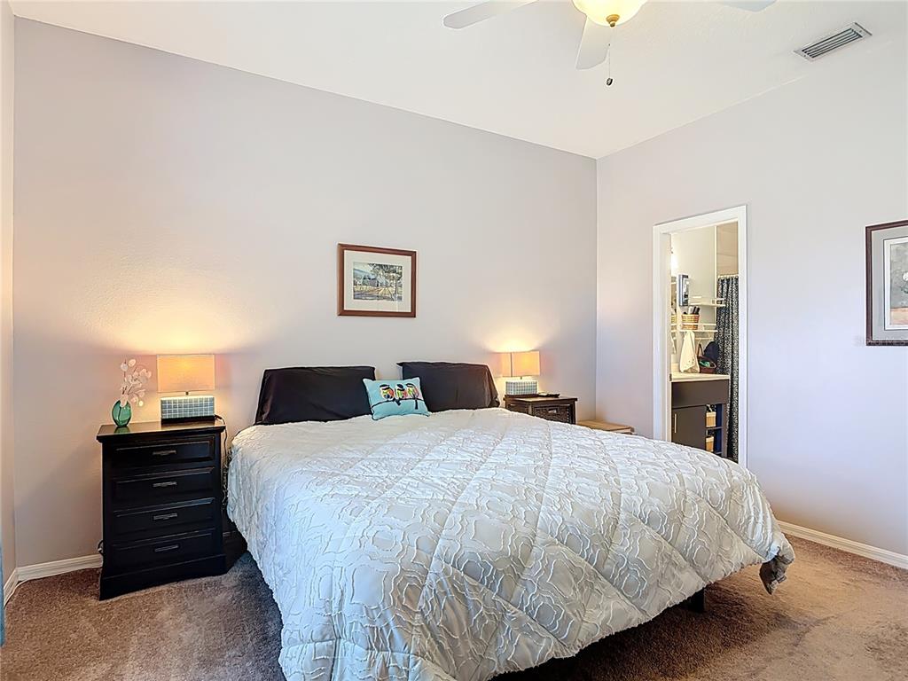 1408 3rd Street Edgewater, FL 32132 - Photo 14 of 43 a bedroom with a bed and painting on the wall