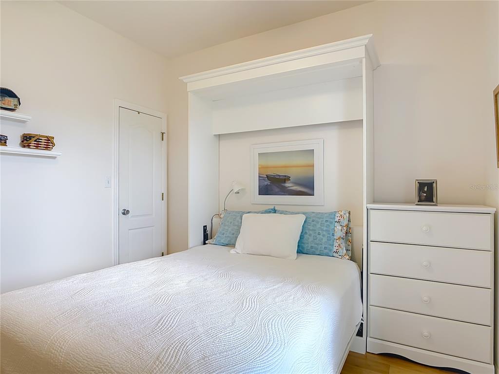 1408 3rd Street Edgewater, FL 32132 - Photo 18 of 43 a bedroom with a bed and a cabinets