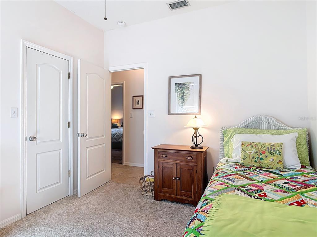 1408 3rd Street Edgewater, FL 32132 - Photo 23 of 43 a bedroom with a bed and a table in it