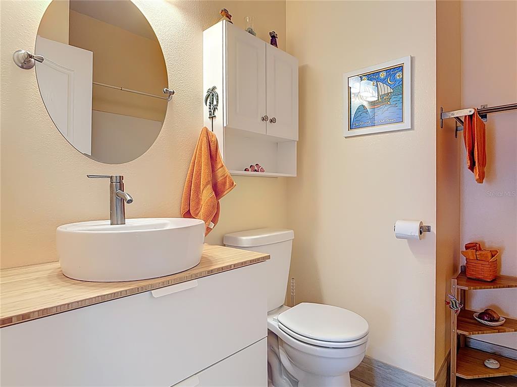 1408 3rd Street Edgewater, FL 32132 - Photo 24 of 43 a white toilet sitting next to a bathroom sink