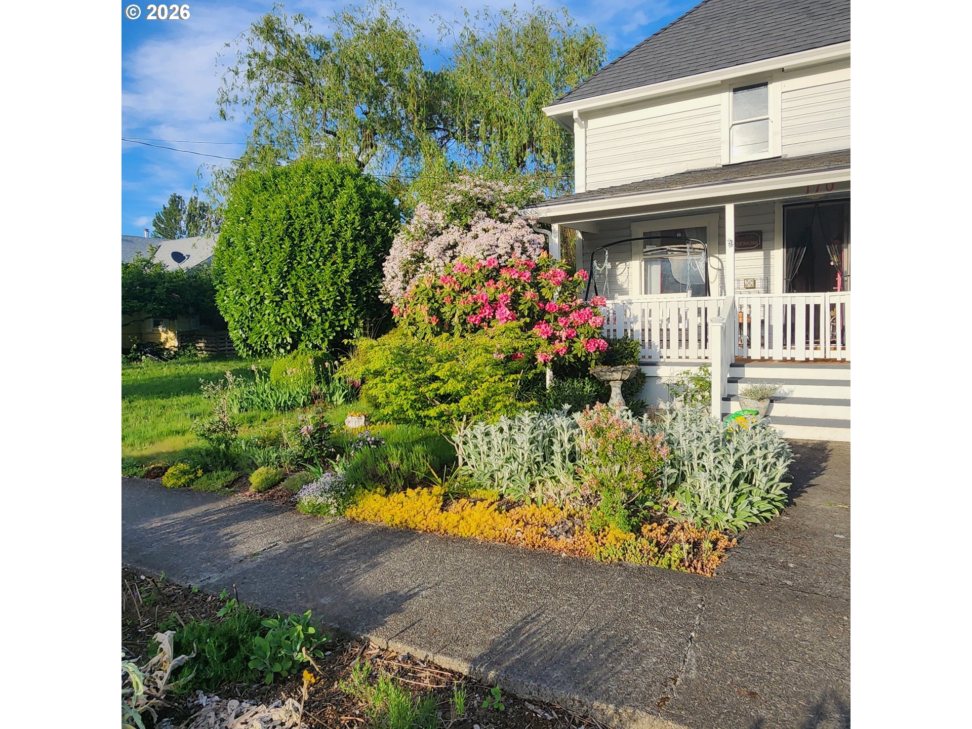 170 Northeast Main Street Estacada, OR 97023 - Photo 39 of 41 a bunch of flowers in front of house