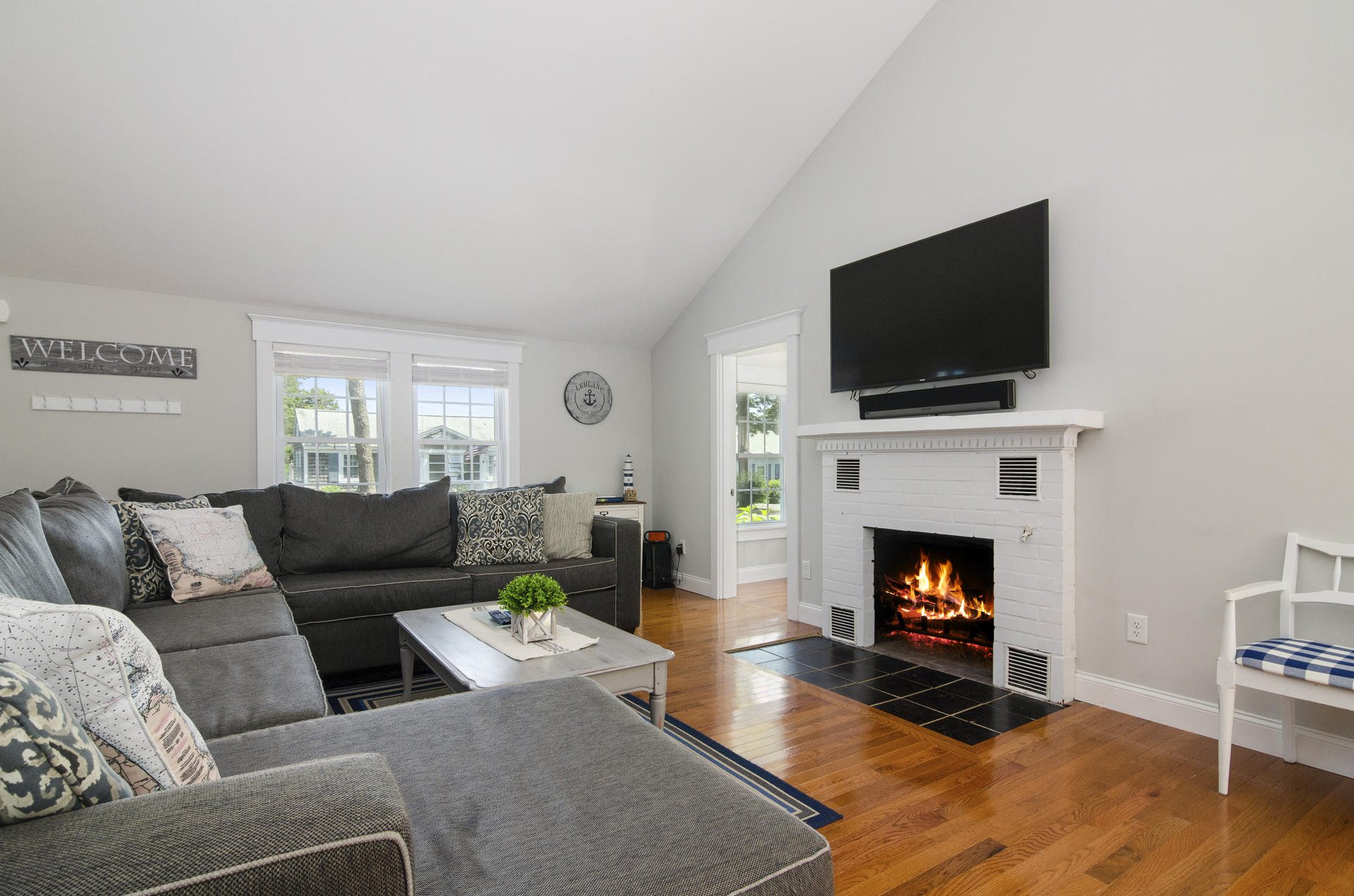 31 Glendon Road Dennis Port, MA 02639 - Photo 3 of 21 a living room with furniture a flat screen tv and a fireplace