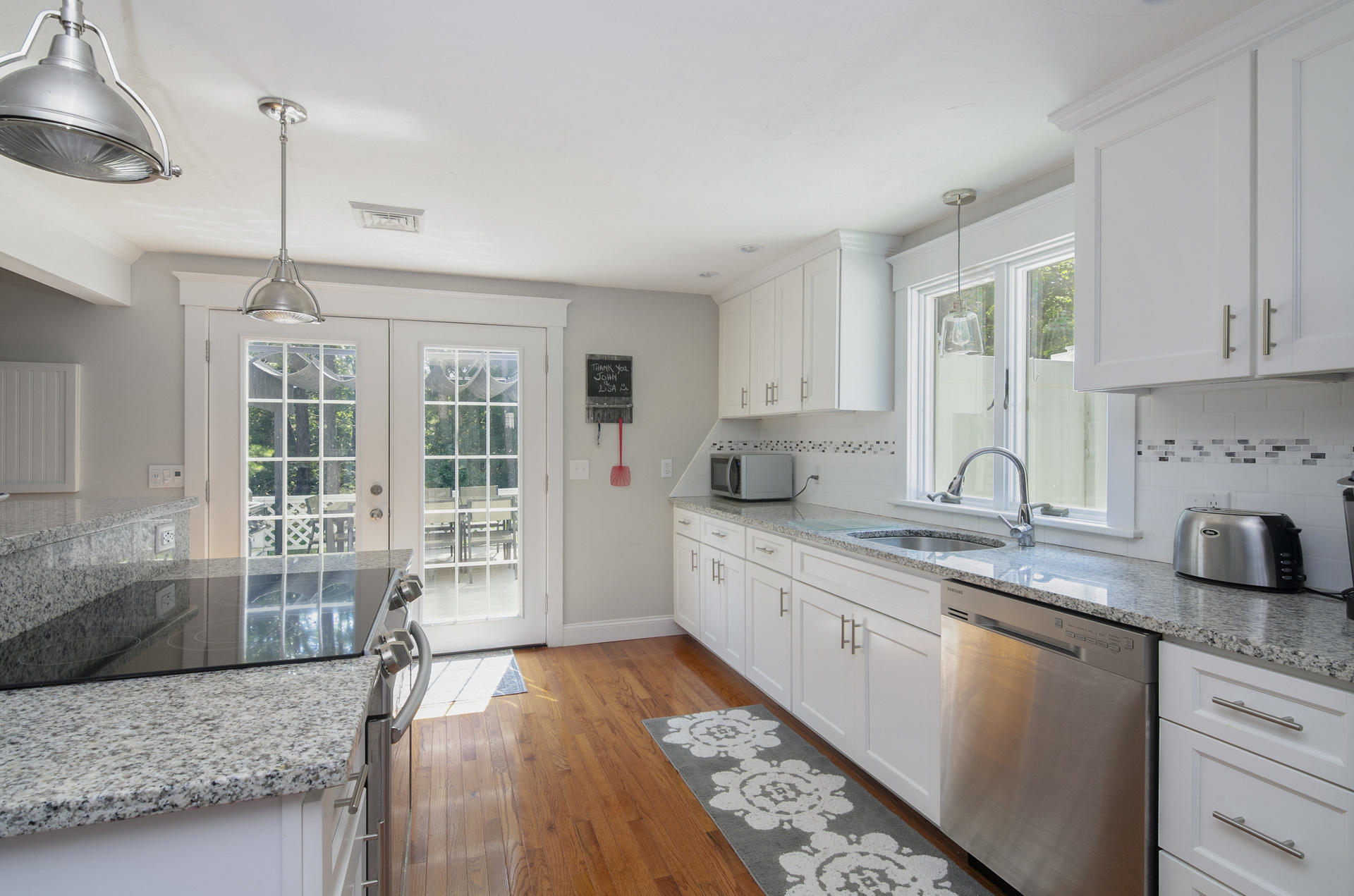 31 Glendon Road Dennis Port, MA 02639 - Photo 7 of 21 a large kitchen with granite countertop a sink a window stainless steel appliances and cabinets