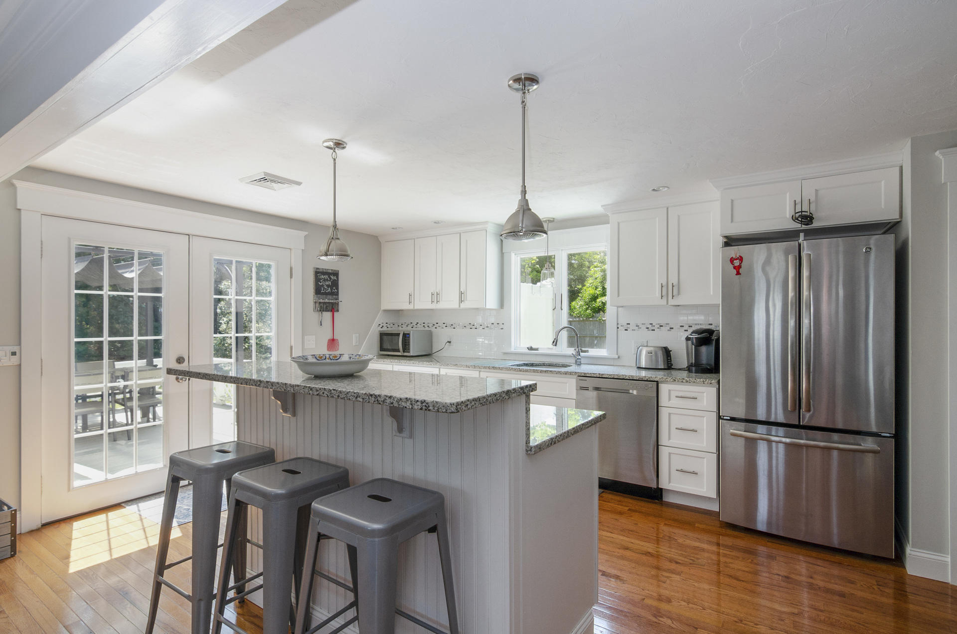 31 Glendon Road Dennis Port, MA 02639 - Photo 8 of 21 a kitchen with stainless steel appliances granite countertop a sink a stove a refrigerator and island with wooden floor