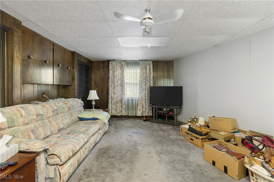627 River Road Canal Fulton, OH 44614 - Photo 20 of 30 Den/family room with wood paneling and carpet