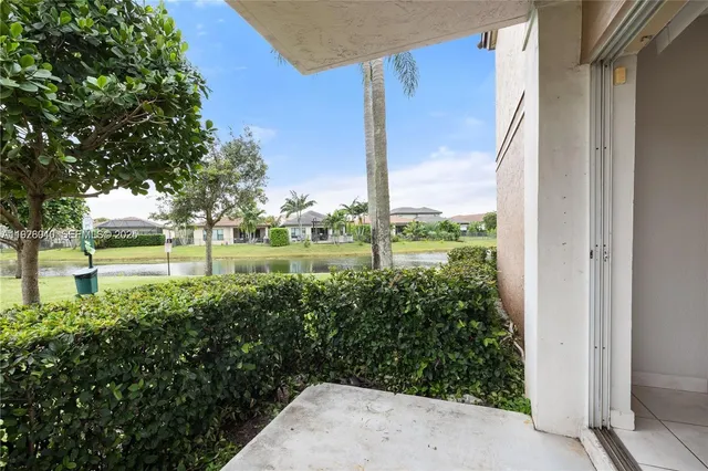 a view of house with a yard and furniture
