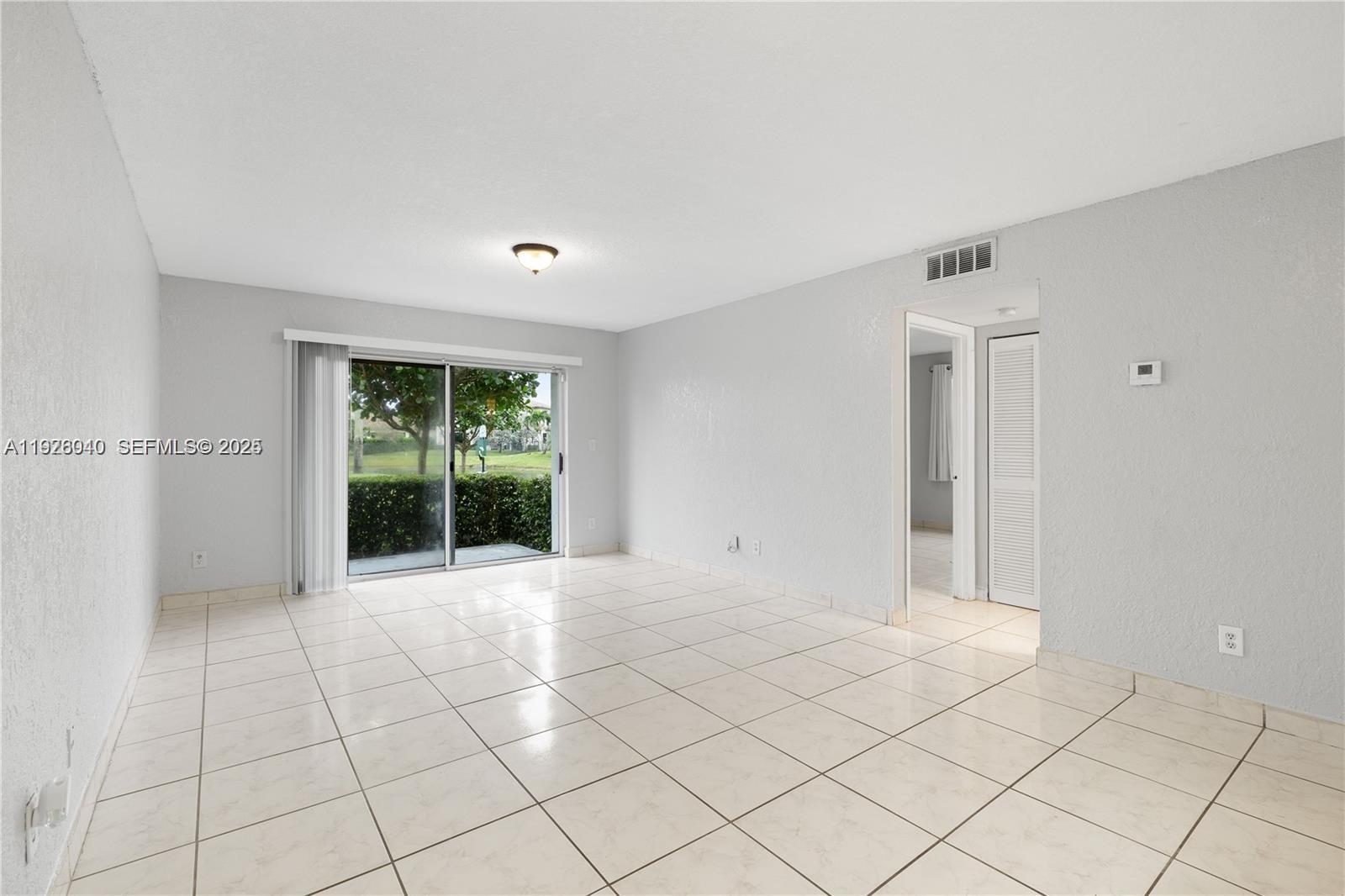 1276 Southwest 113th Terrace, Unit 101 Pembroke Pines, FL 33025 - Photo 15 of 18 a view of an empty room with window and chandelier