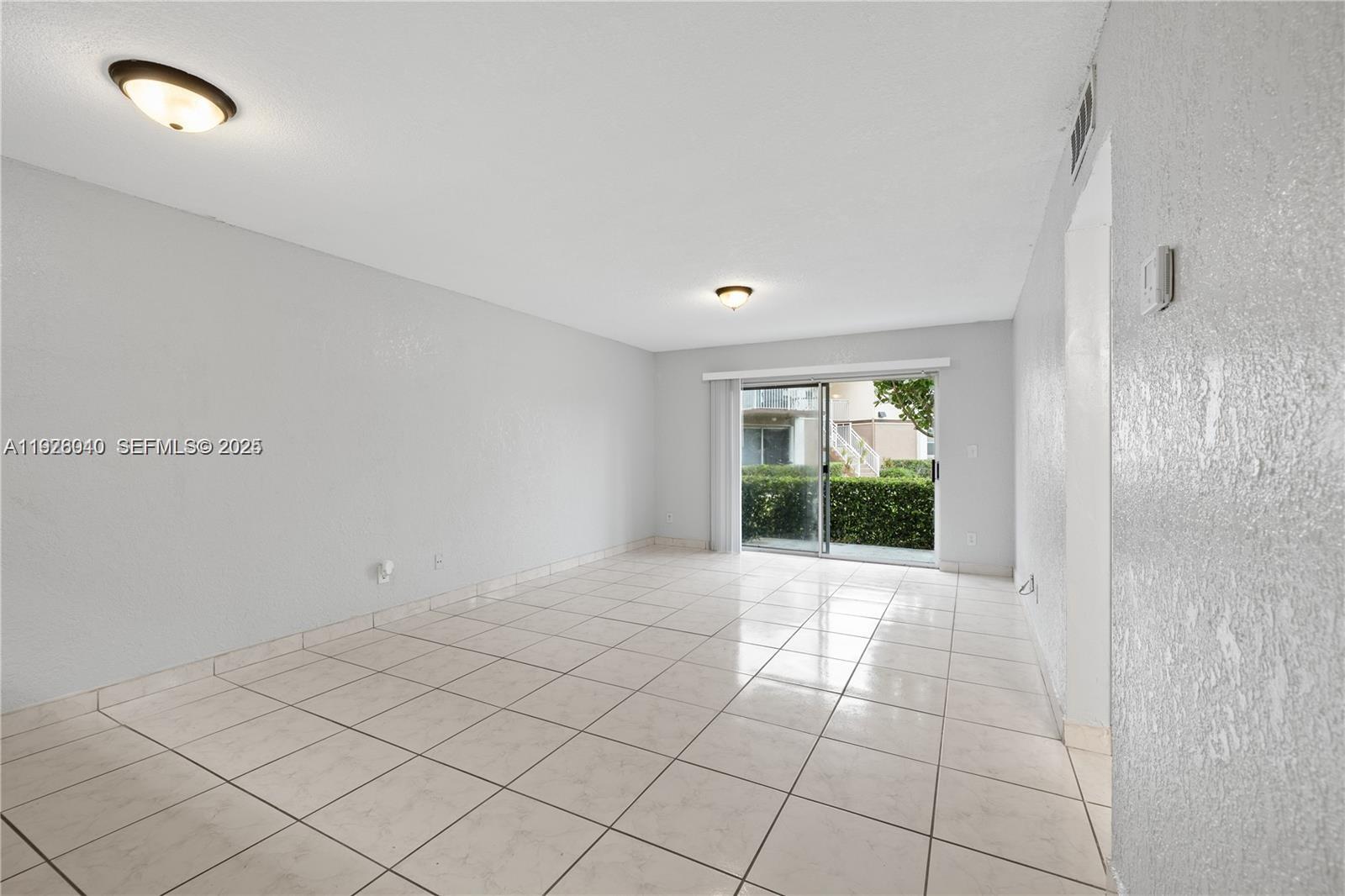 1276 Southwest 113th Terrace, Unit 101 Pembroke Pines, FL 33025 - Photo 4 of 18 a view of an empty room and window