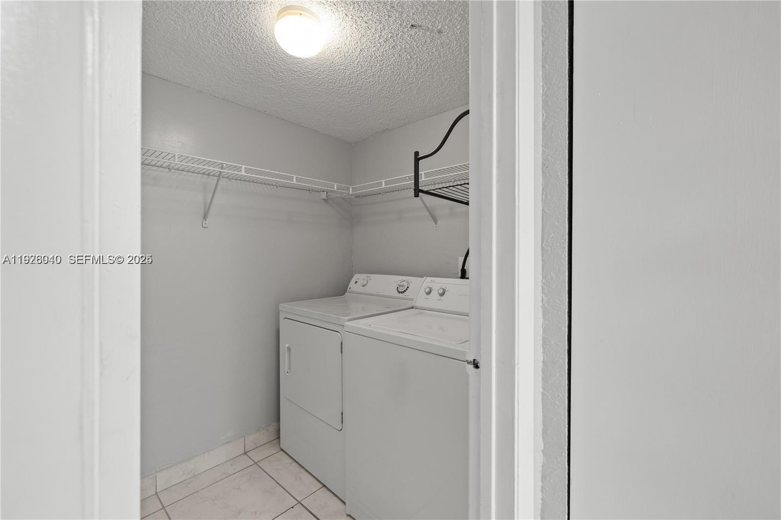 1276 Southwest 113th Terrace, Unit 101 Pembroke Pines, FL 33025 - Photo 7 of 18 a utility room with dryer and washer