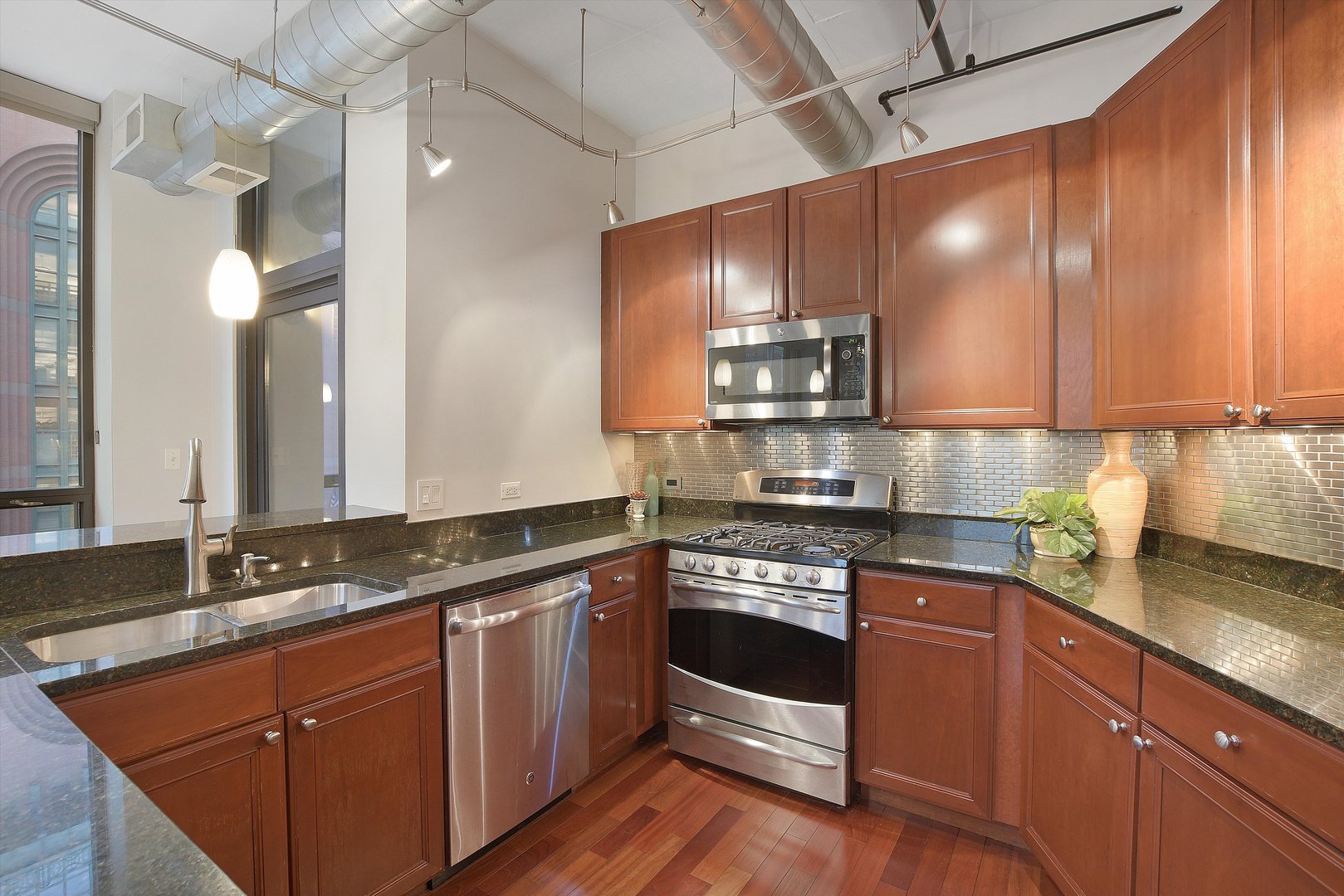 520 South State Street, Unit 510 Chicago, IL 60605 - Photo 12 of 34 a kitchen with stainless steel appliances granite countertop a sink a stove and cabinets
