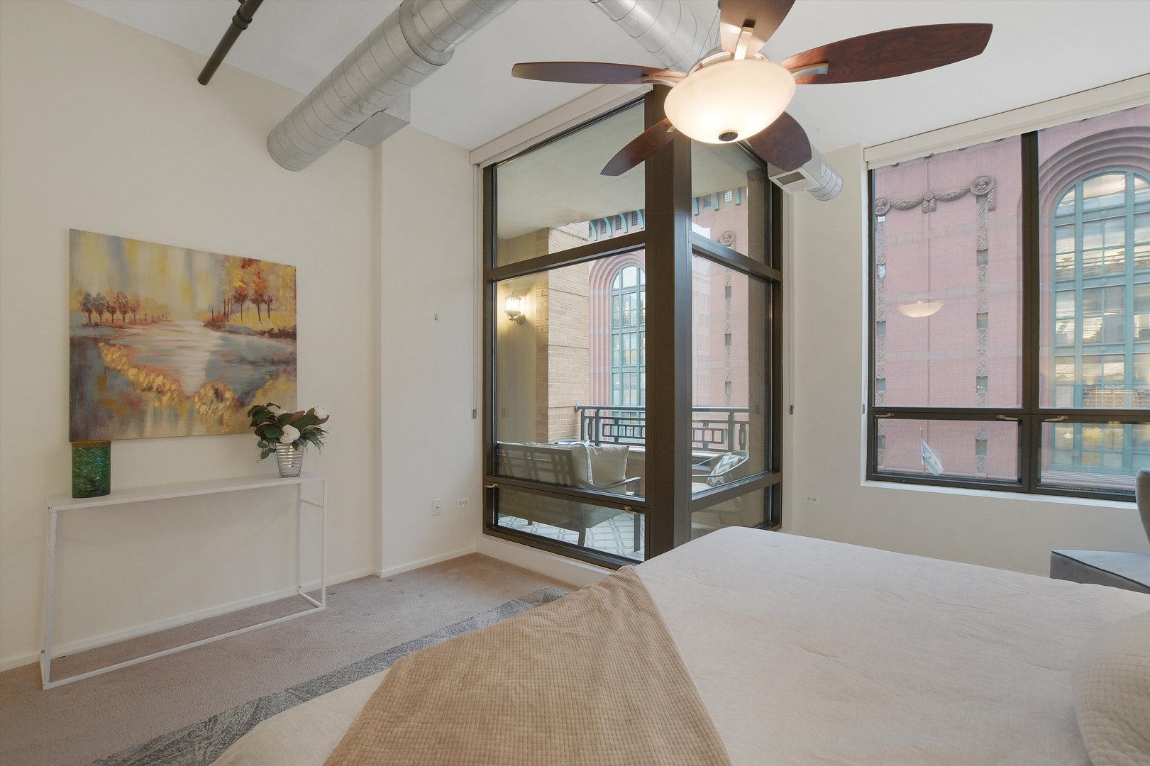 520 South State Street, Unit 510 Chicago, IL 60605 - Photo 16 of 34 a bedroom with a large bed and a chandelier fan