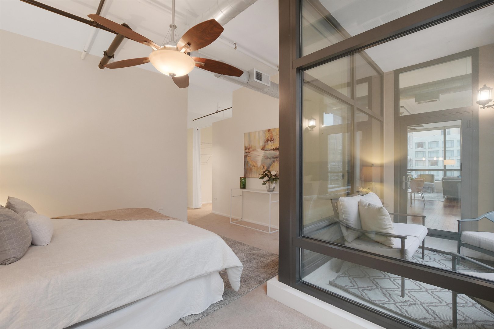 520 South State Street, Unit 510 Chicago, IL 60605 - Photo 17 of 34 a bedroom with a bed mirror and clock on the wall