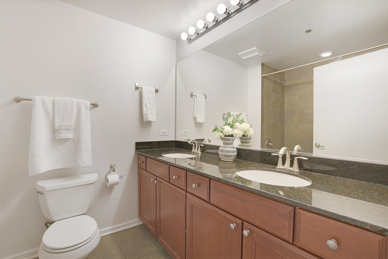 520 South State Street, Unit 510 Chicago, IL 60605 - Photo 19 of 34 a bathroom with a granite countertop sink a toilet and a mirror