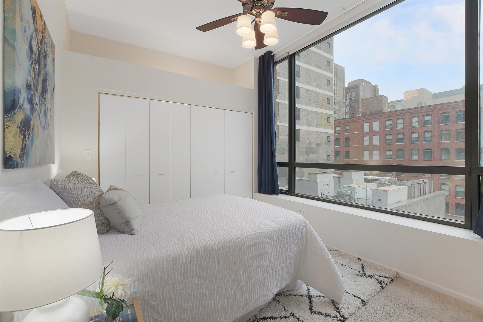 520 South State Street, Unit 510 Chicago, IL 60605 - Photo 20 of 34 a bedroom with a large bed and a chandelier